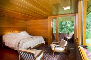 The master bedroom suite realized by Tarantino Architect opens up to an enclosed brick patio.