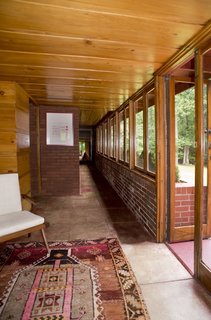 The loggia connects to a long passageway leading to the bedroom wing with the recent master suite addition at the end.