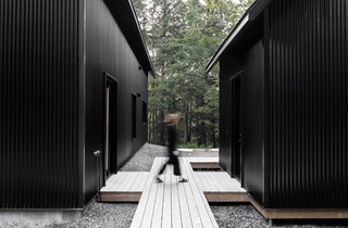 The main entrance to the home is located opposite the door of the outbuilding.