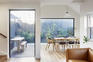 Large walls of glass let plenty of natural light and views into the expanded home.