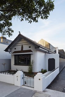 Built in 1938, the Shadow House retains its original curved entry porch.