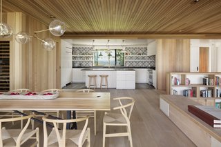 Enveloped in cedar and reclaimed white oak, the interiors exude a sense of warmth.