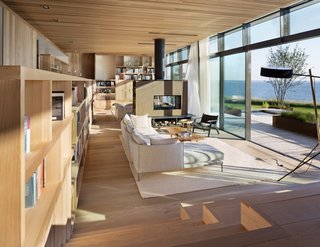 An Acucraft fireplace divides the family room from the living room. The interior flooring is also by Madera-Trade.