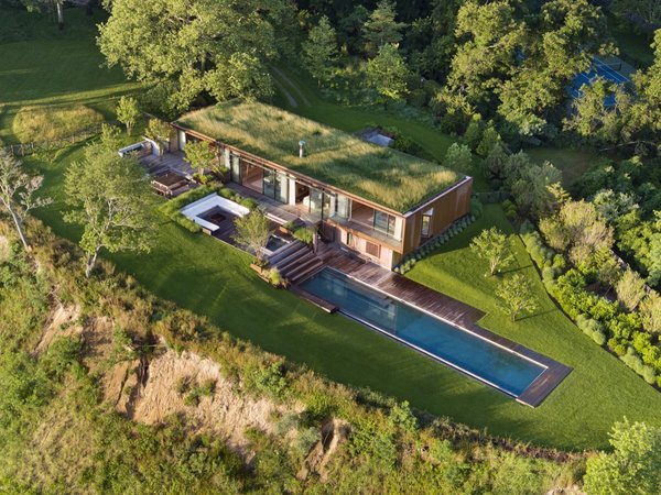The home is located far from the road on the northwest corner of the property and oriented toward views of the water.