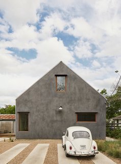 The home's simple gabled shape is emphasized by the use of burnished stucco on all sides.