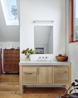 Like the kitchen, the closet vanity features stained white-oak cabinetry.