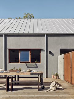The pine-and-steel outdoor dining table is from Hatch Workshop, while the benches were built by Clifton Craftwork and Design.