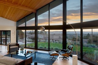 The house was dramatically opened up with the addition of a vaulted living room ceiling and walls of glass.