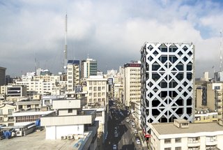Wrapped in an energy-efficient, double-skin facade of glass and composite aluminum panels, this 12-story office tower in Tehran features a pattern referencing the motif a mandala.