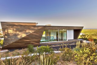 Located on the far end of Provincetown, Massachusetts, the Beach House boasts 2,400 square feet of prime waterfront real estate within a sculptural, timber-clad volume inspired by the landscape.