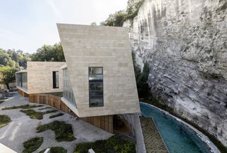 A narrow creek was carved into the edge of the rock wall to "extend nature into the site."