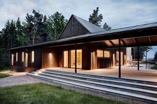 "The roof that connects the two volumes makes it possible to use the patio even when it rains or when the dew settles," note the architects. "This way the house is adapted for Swedish summer— it works in all kinds of weather."