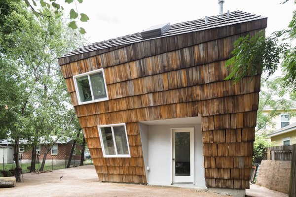 The one-bedroom abode features a wood-and-steel frame clad in oversized cedar shakes repurposed from the roof of another home.