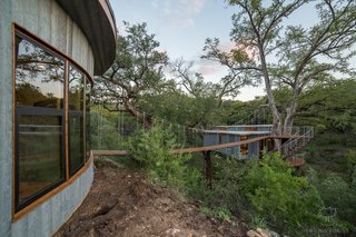 A 60-foot-long suspension bridge links the treehouse with the detached bathhouse.