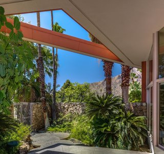 Landscaped with palms and other leafy greens, the house feels like a tropical paradise.