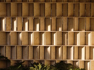 A close up of the limestone partition reveals how the angled surfaces are spaced slightly apart to allow wind through.