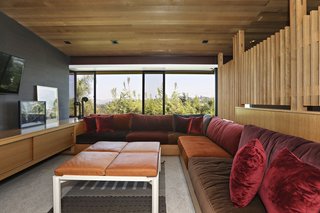 An L-shaped couch delineates the TV lounge room.