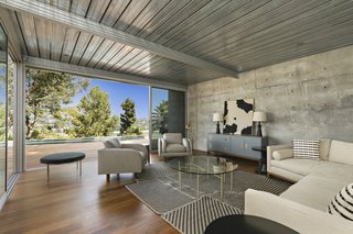 The guest quarters include a spacious living area that opens up to a private deck with a glimpse of a plunge-sized swimming pool and spa.
