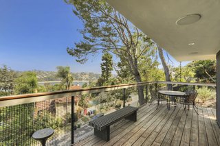 Multiple outdoor living spaces and a wraparound deck emphasize indoor/outdoor living.