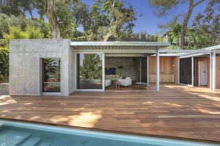 The new 1,000-square-foot addition is made of poured concrete and features full-height sliding doors that connect to the wood deck.