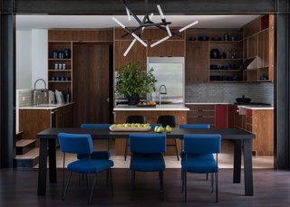The open kitchen features Pental Quartz countertops, walnut plywood cabinetry by Kerf Design, and a ceramic tile backsplash from Ann Sacks Savoy Collection. The Muuto Nerd counter stools are from DWR.