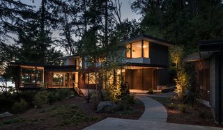 Set on a one-acre wooded bluff overlooking Puget Sound, the Tree House is clad in low-maintenance materials including Cor-Ten steel, stained cedar shiplap, and painted HardiePlank.