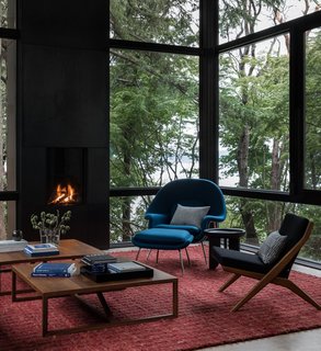 The side chair is a Vintage Dux Scissor chair by Folke Ohlsson. The coffee tables are Blu Dot Strut tables in walnut.