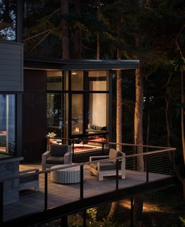 The outdoor patio features St. Kitts lounge chairs from Frontgate and a black and white bone inlay coffee table.