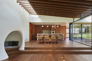 Teak is used extensively throughout the home—from the flooring to the kitchen cabinetry. The dining chairs and table are by George Nakashima.