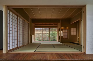 A traditional tatami room with shoji sliding doors is located next to the open-plan living space.