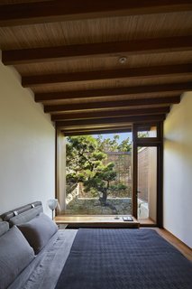 The guest bedroom, located on the south side of the site, overlooks a Japanese pine tree.