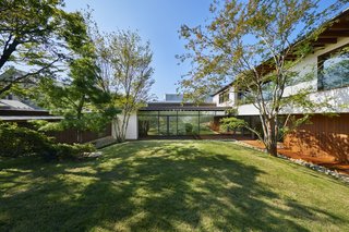 The site slopes east to west. The open-plan living areas (seen directly ahead) are located on the west side and the highest point of the site for expansive garden views.