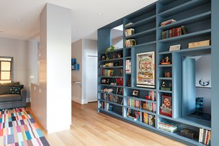 On the basement level, the Megacabinet shelving is mainly used for books and toys. The floors throughout the home are engineered white oak.