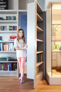 On the first floor, the office powder room is hidden behind a door disguised as a bookshelf.