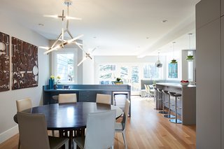 The Crate & Barrel dining table is paired with Bottega Side Chairs in Ice Grey from Design Within Reach.