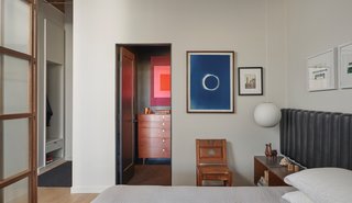 A view from the bedroom towards the closet with a glimpse of the entry hall on the far left.