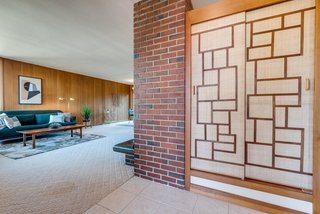 A look at the entry foyer with a closet sheathed behind sliding doors on the right and the living area to the left.