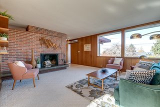 Large custom windows frame the front of the residence.