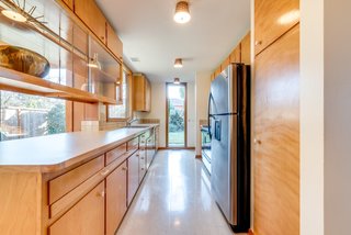 The home's midcentury details are still intact, save for the flooring, appliances, and Formica countertops which have been replaced.