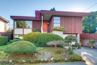 Located in NE Portland on a 0.12-acre lot, the well-preserved home is clad in board-and-batten cedar siding.