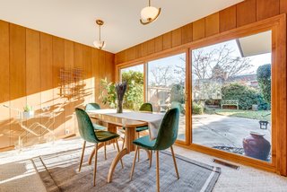 Floor-to-ceiling windows pull views of the backyard patio into the dining area.