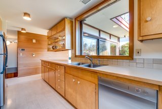 A large window over the sink overlooks the backyard and gives the room a spacious feel.