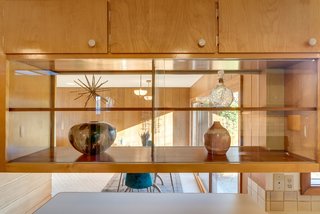Open shelving creates flow between the kitchen and dining room.