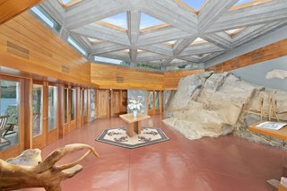 The naturally occurring "whale rock", a key part of Wright's sketches, cuts into the dramatic entry hall that's bathed in natural light. The massive rock measures 12 feet in height and 60 feet in length.