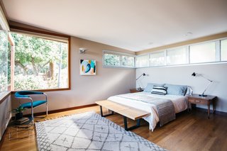 Anchored by a vintage Thonet cantilever chair, the master bedroom is filled with natural light and views of the outdoors.
