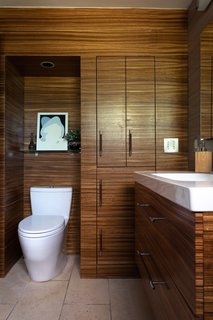 The bathroom cabinetry is made of Zebrawood. The floor is limestone tile.