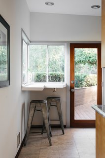 A snug breakfast nook in the kitchen overlooks mountain and city views below.