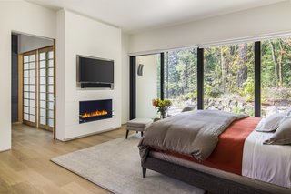Sliding doors in the master bedroom open to an outdoor walkway that connects to the outdoor spa, patio, and garden.