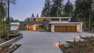 "Great care was taken to preserve all fir and maple trees on the site and to compliment the new landscaped areas to highlight the natural setting," the architects note of their site-sensitive approach.