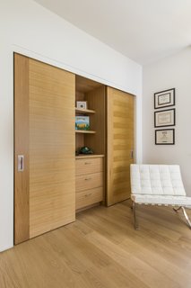 The small second floor includes two bedroom suites (for the client's visiting children or guests), a lounge, and a covered terrace.